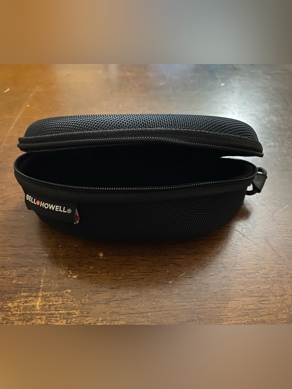 Black sunglasses/glasses case.  Hard cover